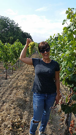 Chrystal Clifton standing in the vineyard