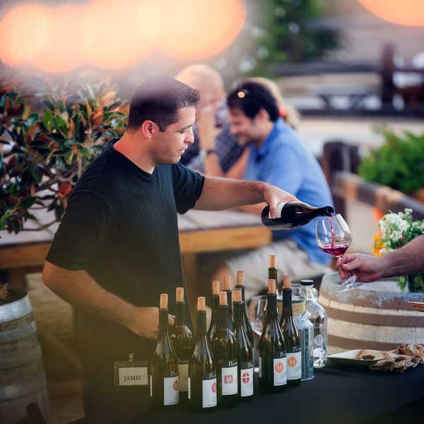 Pouring Wine at a Palmina Wines Club Party